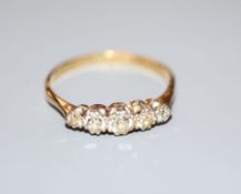 An 18ct gold and graduated five stone diamond ring, size P, gross 2.1 grams.