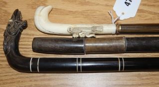 A 19th century ivory handled horn walking stick and two banded horn walking sticks faults 66.5 -