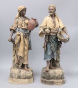 A pair of Austrian earthenware figures of street vendors, by Johann Maresch, height 48cm