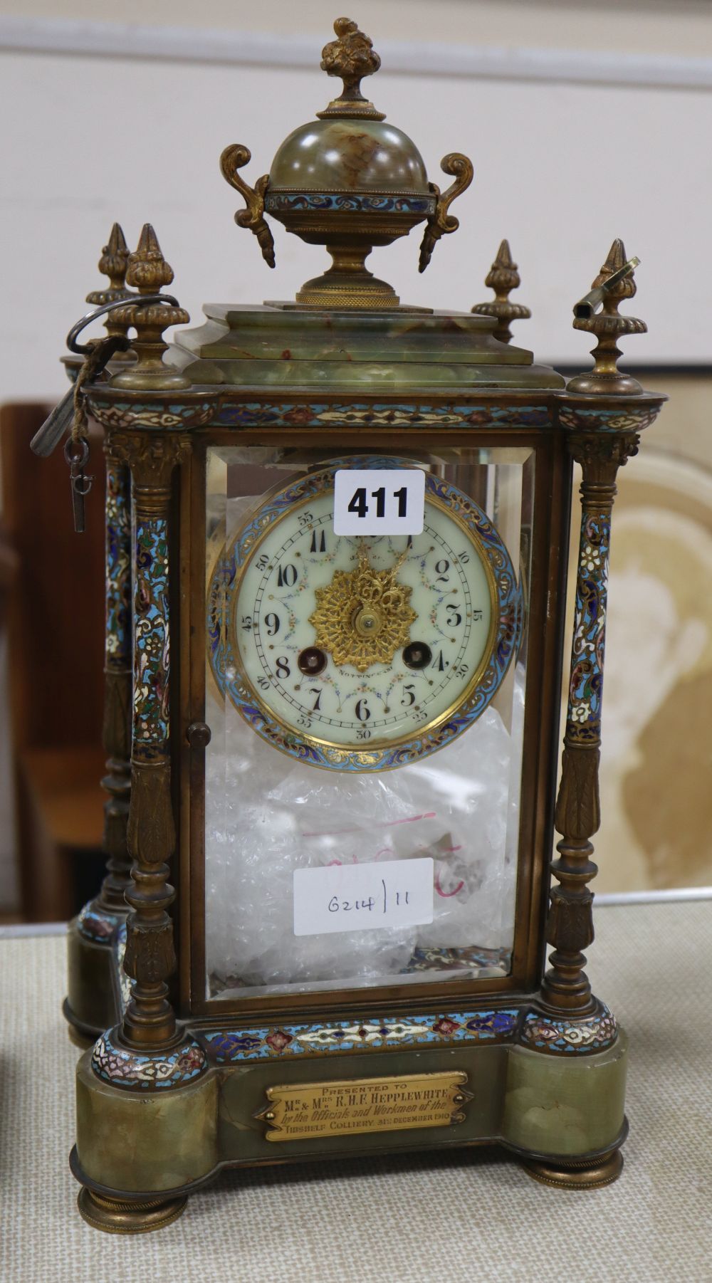 An Edwardian champleve enamel and onyx four glass clock, with presentation plaque, H.40cm