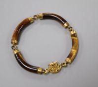 A Chinese 14k and tiger's eye quartz link bracelet (one link cracked and glued), gross 22.4 grams.