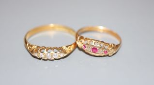 A George V 18ct gold and graduated five stone diamond ring, size X and a similar ruby and diamond