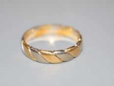 A modern two colour 18ct gold wedding band, size W, 6.5 grams. ,