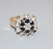 A modern 9ct gold, sapphire and diamond cluster ring, size M, gross 4.9 grams.