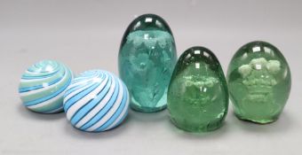 Two glass swirl paperweights and three glass dump paperweights, one with Prince of Wales feathers