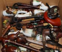 A collection of late 19th/early 20th century German porcelain and treen smoking pipes
