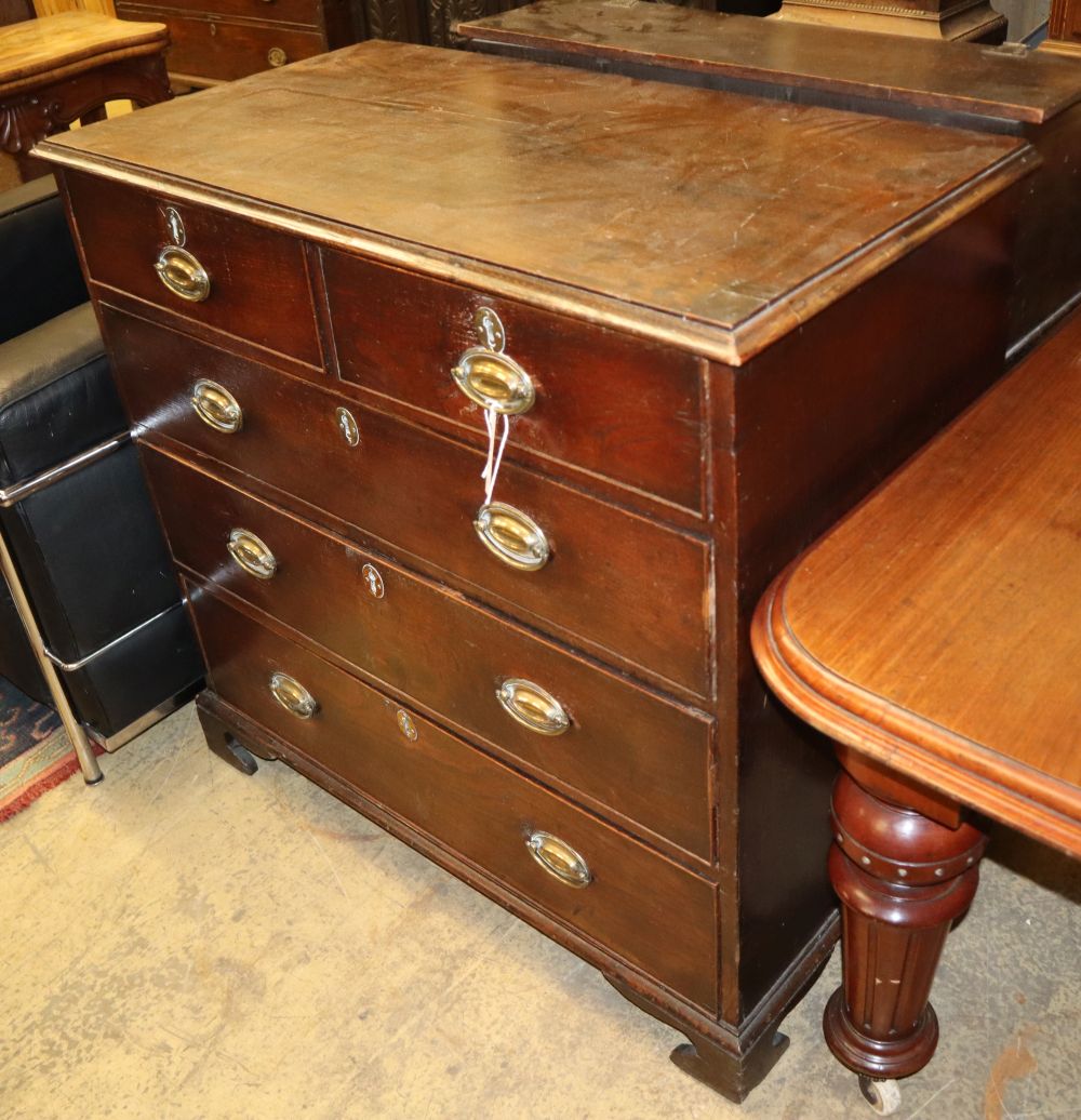 An 18th century oak chest fitted two short drawers and three long drawers with brass handles, on