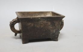 A Chinese bronze two handled censer, W.16cm including handles