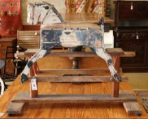 An early 20th century naive wood rocking horse, L.82cm, H.69cmCONDITION: Very heavily play worn,