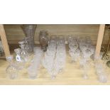 A quantity of cut glass drinking glasses, decanters and vases