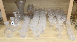 A quantity of cut glass drinking glasses, decanters and vases