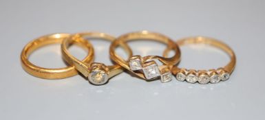 A 22ct gold wedding ring, 4.4 grams and three 18ct gold diamond-set rings, gross 5.9 grams.