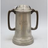 A 19th century pewter lidded twin handled tankard