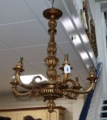 A carved giltwood six branch chandelier ceiling light