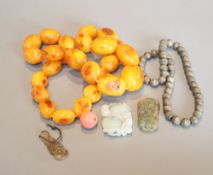 A group of Chinese jewellery to include an amber necklace and a bead necklace