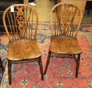 A set of four reproduction elm and beech Windsor wheelback dining chairs