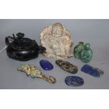 A group of Chinese hardstone carvings, including a Buddha, a lapis lazuli teapot, a belt hook, etc.
