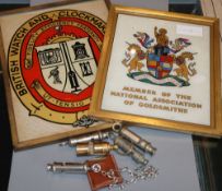 A Hermes cigar cutter, five whistles, A British Watch and Clockmaker's Guild framed logo and