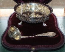 A cased Victorian repousse silver sugar bowl and sifter spoon, Charles Edwards, London 1890, bowl