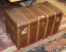 An early 20th century travelling trunk containing a large quantity of assorted linen and mixed