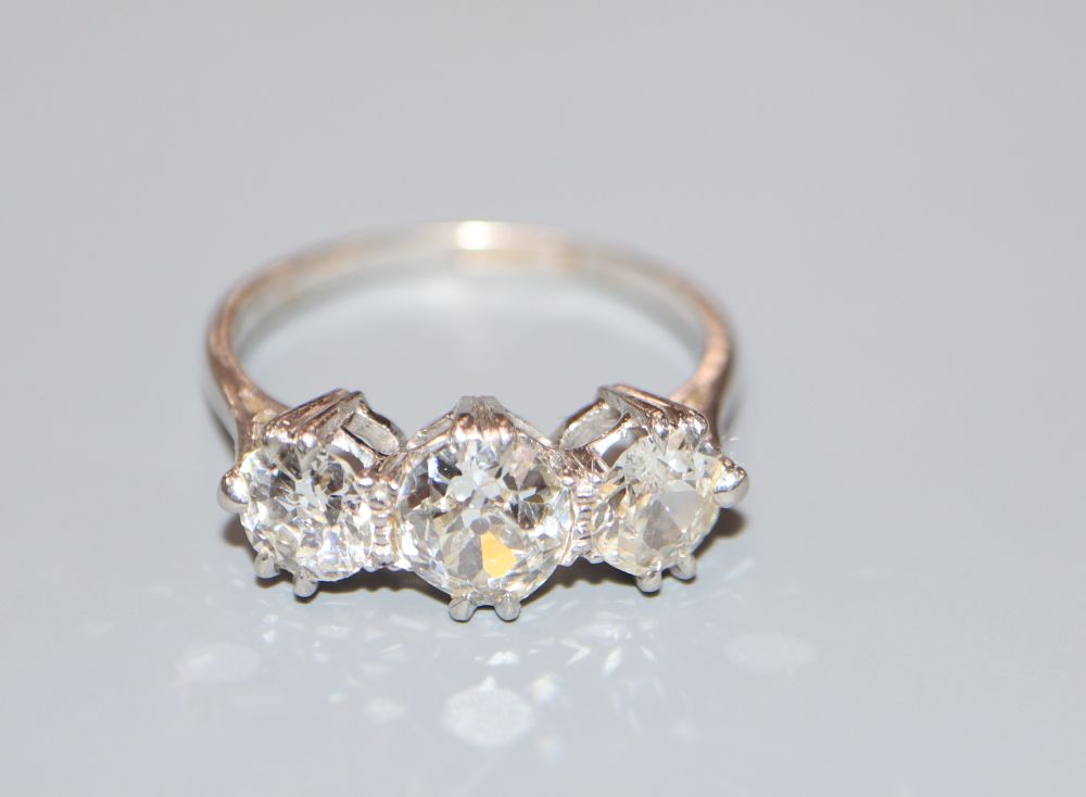A platinum and three stone diamond ring, size N, gross 4.1 grams.CONDITION: Central stone approx.