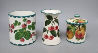 A Wemyss lidded jam pot, a vase decorated with strawberries and another fluted vase decorated with