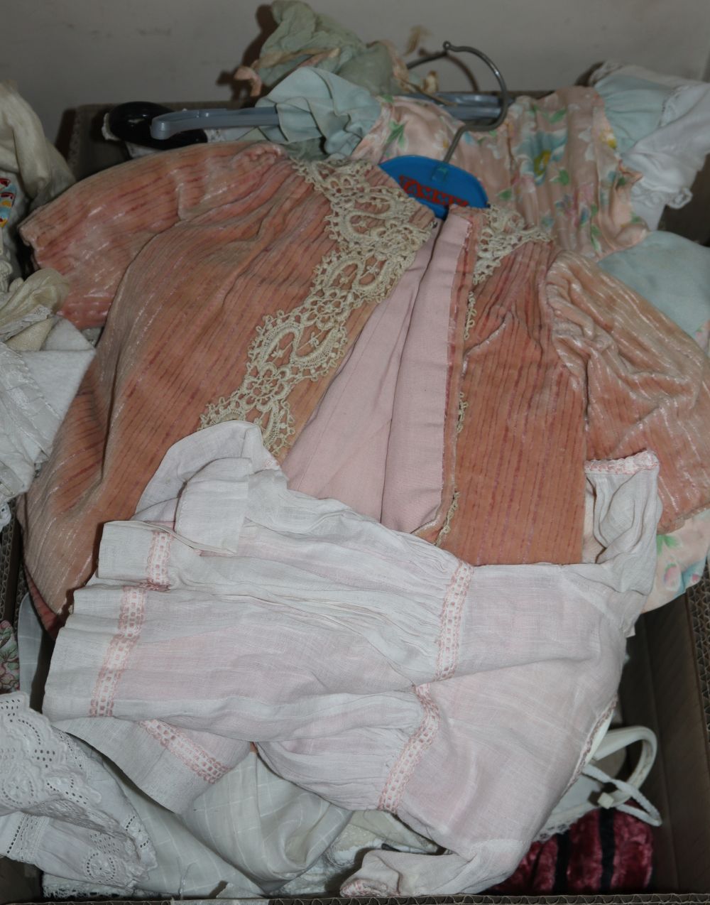 A quantity of vintage and later dolls clothes