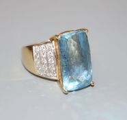 A modern 18ct gold and fancy cut aquamarine dress ring, with pave diamond set shoulders, size N/O,