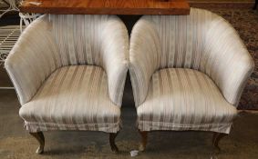 A pair of upholstered tub chairs