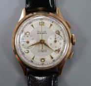 A gentleman's 1950's 18k Dulux chronograph manual wind wrist watch, on later associated strap.