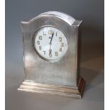 A George V engine turned silver mantel timepiece, W.G. Sothers Ltd, Birmingham, 1921, height 14cm.