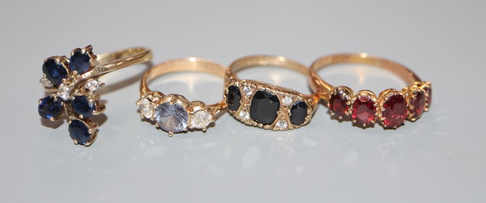 Four assorted 9ct gold dress rings including an early 20th century five stone garnet half hoop ring,