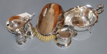 Four assorted silver condiments, a silver sauceboat and a white metal mounted clothes brush.
