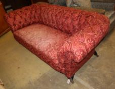 A late Victorian Chesterfield settee upholstered in buttoned red fabric, W.200cm, D.94cm, H.