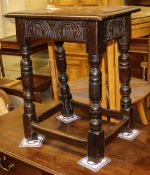 An antique carved oak joynt stool with later top, W.44cm, D.28cm, H.53cm