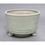 A Chinese celadon jar, height 11cmCONDITION: One of the feet has several cracks to the surrounding