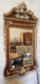 An 18th century style parcel gilt mahogany wall mirror in the manner of William Kent, W.74cm, H.