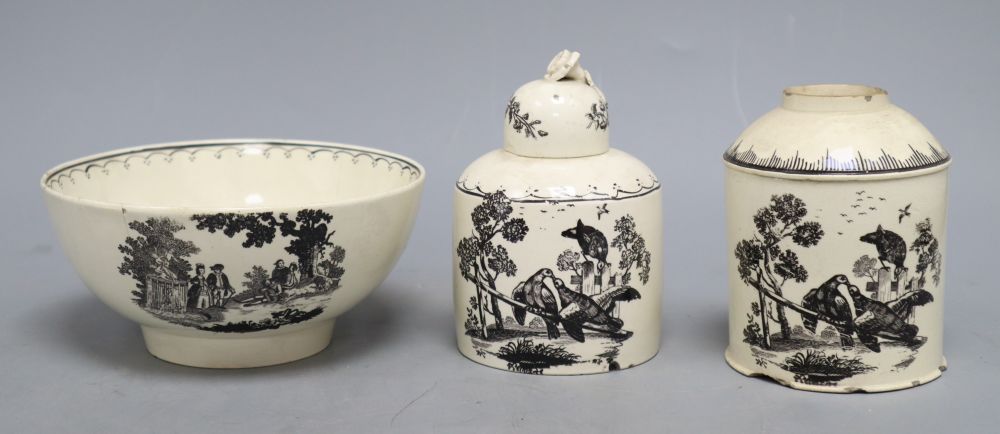 A late 18th century black transfer printed creamware bowl, diameter 14.5cm and two caddies with