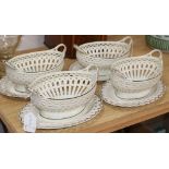 A pair of late 18th century creamware chestnut baskets and stands, a similar pair of baskets with