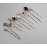 Ten assorted 19th century and later yellow metal and gem set stick pins, including garnet and enamel