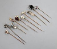Ten assorted 19th century and later yellow metal and gem set stick pins, including garnet and enamel