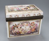 An Italian pottery casket, probably Naples, relief moulded and painted with scenes of revelry and