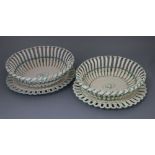 Two late 18th century Wedgwood creamware chestnut baskets and stands, length 30cm