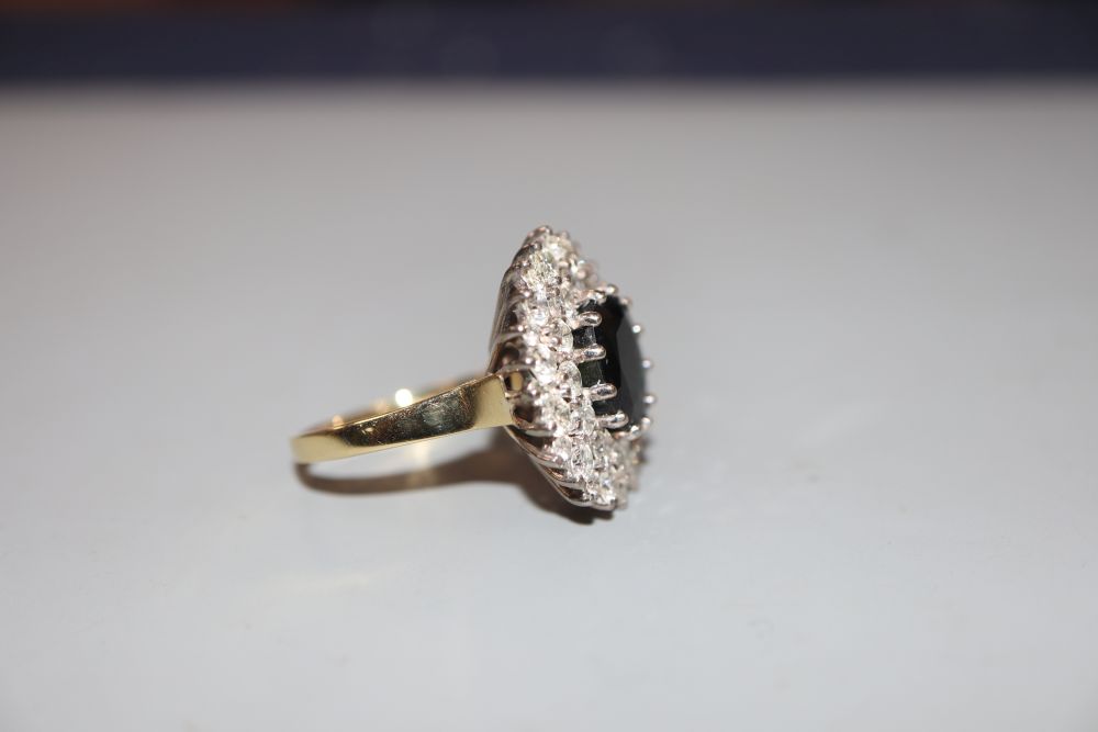 A modern 18ct gold, sapphire and diamond set oval cluster ring, size L, gross 7 grams.CONDITION: - Image 2 of 3