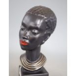 A 1960's ceramic bust of a tribal woman, signed, height 22cm