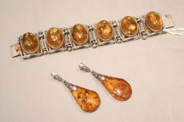 A white metal and amber cabochon set bracelet, 17cm and a pair of similar drop earrings, 6cm.