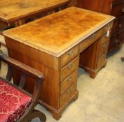 A George I style burr walnut pedestal desk, W.115cm, D.62cm, H.73cmCONDITION: The top is generally
