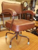 A 1950's adjustable leatherette desk chairCONDITION: The leatherette seat is dry and cracked in