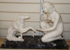 An Art Deco white marble model of a nude with a dog, after Chiparus, width 62cm height 42cm (a.f.)