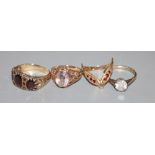 Four assorted 9ct gold and gem set dress rings including Victorian style garnet ring, gross 12.8